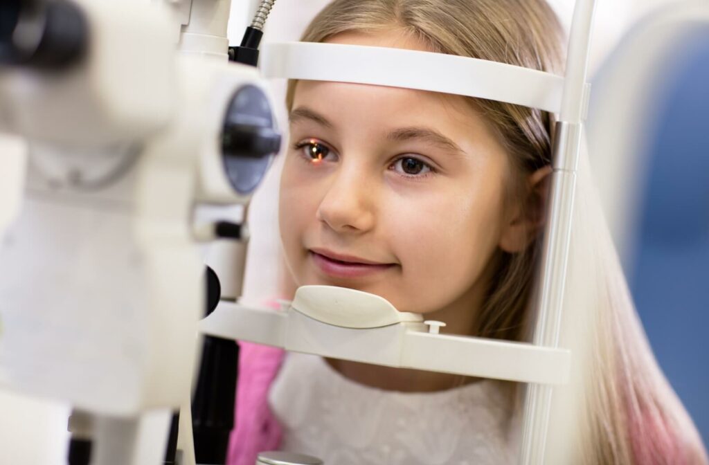 A young girl has her eye health assessed during a comprehensive eye exam.