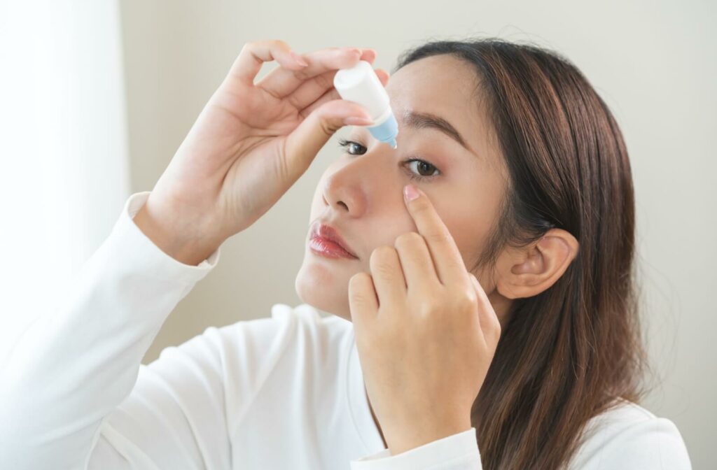 An adult uses lubricating eye drops to get relief from their dry eye symptoms and to prevent complications.