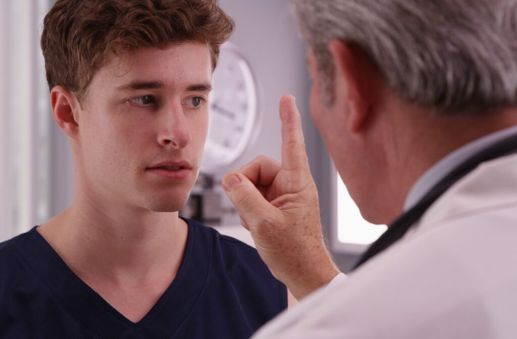 A young patient having their eyes checked by an eye doctor to determine if they require vision therapy.